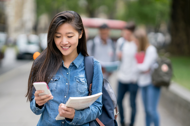 Student smiling on phone